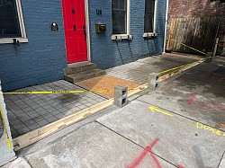 We laid a sheet of plywood temporarily over the wire reinforcement so the customer can still access their front door safely until we start the concrete pad.