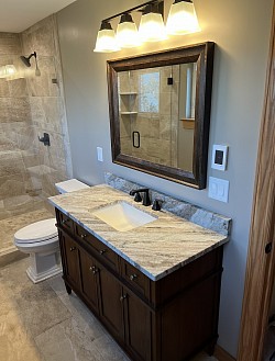 The vanity, mirror, and light coordinate well with each other.