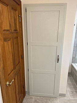 We framed and built this linen closet along with the custom door painted and color matched to the vanity cabinetry.