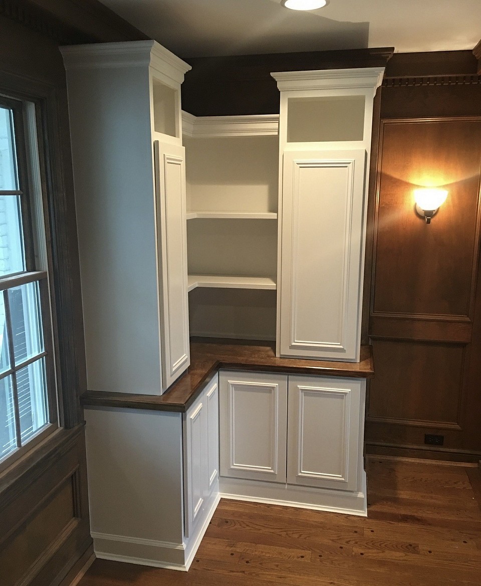 Completed with stained countertop, painted base cabinets, and upper book shelves.